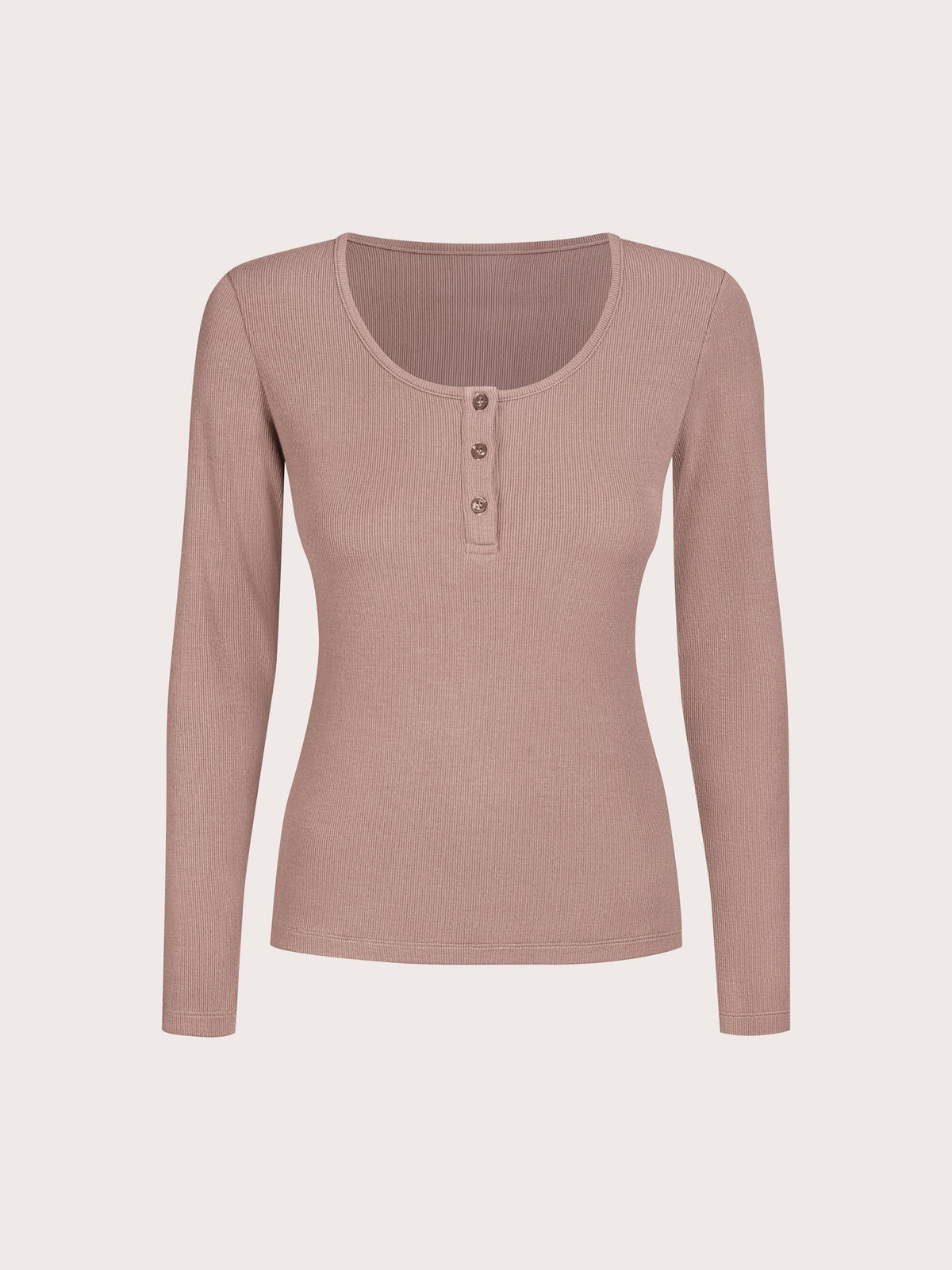 A long-sleeve ribbed knit henley top in a dusty rose pink color, featuring a scoop neckline and three decorative buttons on the chest, displayed against a solid off-white background.