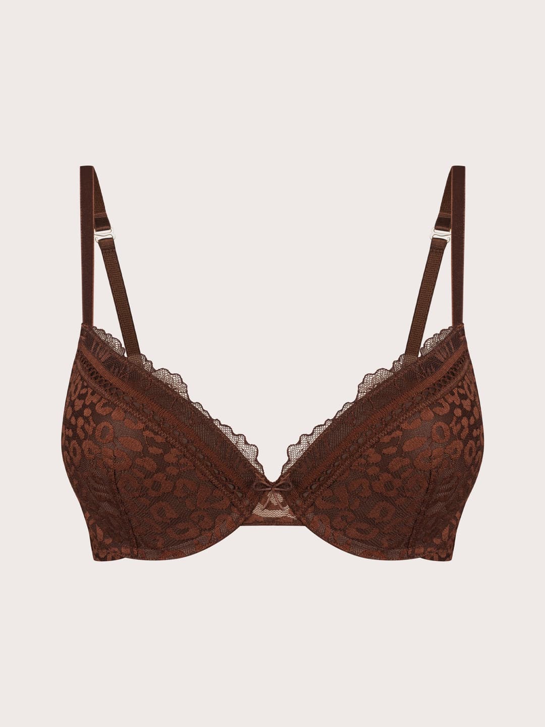 A brown lace underwire bra with adjustable shoulder straps, displayed against a solid light beige background.